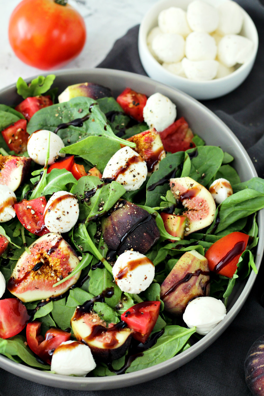 Trader Joe's Inspired Black Fig and Balsamic Salad with tomato and fresh mozzarella balls also sitting in photo.