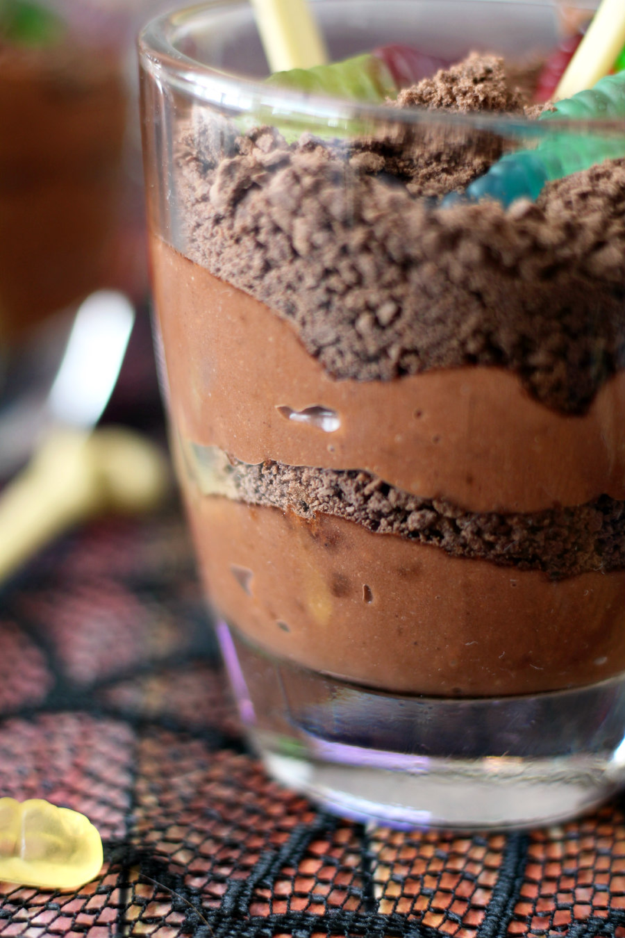 Closeup photo of layers of pudding and cookies crumbles in a glass.