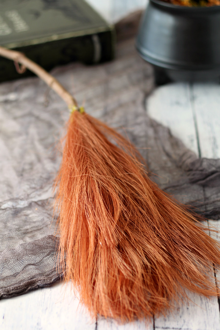 Brown pampas grass hot glued onto grapevine stem to create a witch's broomstick.